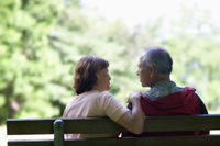 older couple on bench speaking to one another