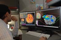 Scientist looking at brain images with fMRI data