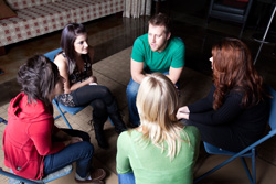 Teens talking in group session.