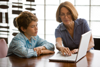woman and boy using a laptop