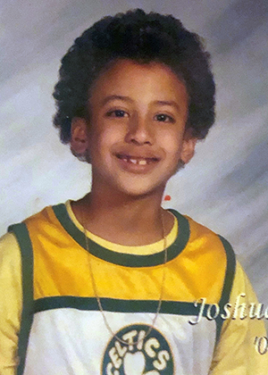 A childhood photo of Josh Santana in Boston Celtics jersey.