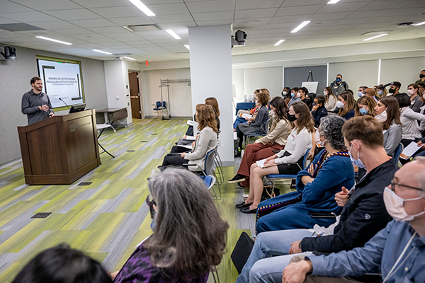 male scientist presenting to group