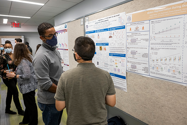 two men looking at a poster