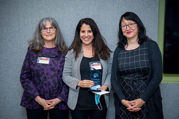three female scientists with award