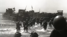American service members conducting an amphibious landing on the beach in WWII