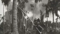An American service member raises the flag in the jungle during World War II.