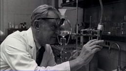 Dr. Julius Axelrod examines scientific equipment in the lab in 1973.