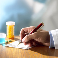 Person writing prescription for medication