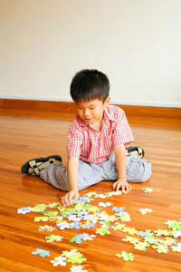 A boy playing with a puzzle