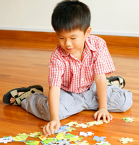 boy playing with a puzzle 