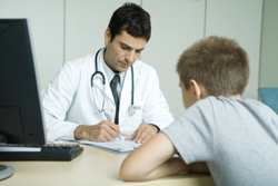 boy and doctor sitting at desk