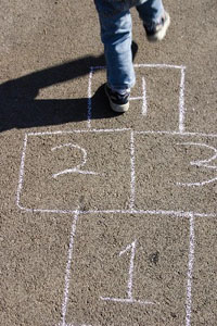 child playing hopscotch