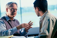 Two men talking at a table