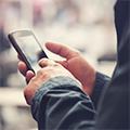 a man's hands hold a smartphone