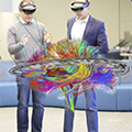 Enhanced photo of researchers standing and wearing virtual reality headsets to plan DBS implantation.