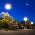 photo of residential street with bright street lights at dusk