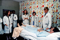 hospital room scene with patient and doctors