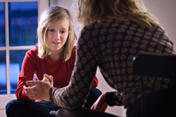 young girl talking to therapist