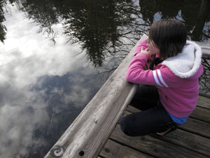 teen girl looking at a lake