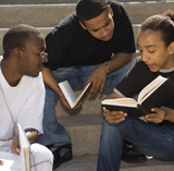 three male teens studying 