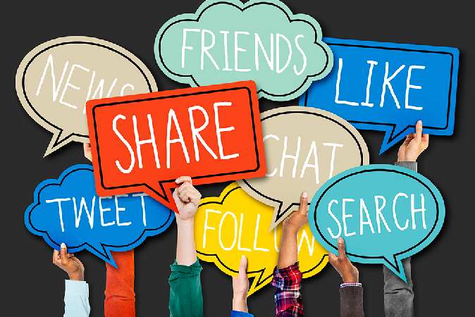Image of hands holding speech bubbles containing social media terms like share, tweet, and follow.
