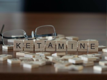 Scrabble pieces spelling out the word "ketamine."
