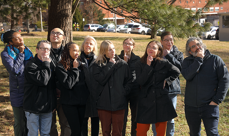 SDN staff posing for a group picture while striking a thinking pose