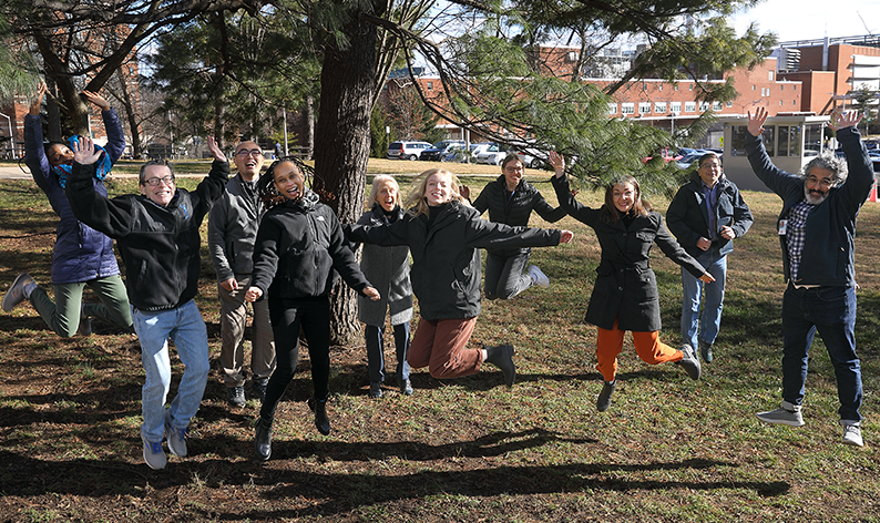 SDN staff jumping off the ground as a group.