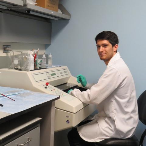 Mike (postbac IRTA) sitting in the histology room cutting fine tissue sections on a cryostat