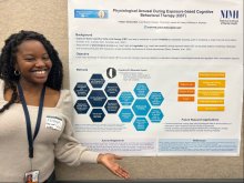 Faithyn Chukundah stands in front her poster at NIH Summer Poster Day.