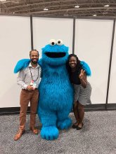 Kenny Fling and Ayo Telli pose with Cookie Monster at the American Psychological Association annual meeting.