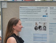 Dr. Simone Haller standing in “profile” in front of the Neuroscience and Novel Therapeutics Unit poster to mimick the fMRI paradigm being presented at the NIMH 75th Anniversary event. 