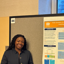 Image of Ayo Telli in front of her poster at AACAP