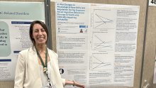 Lana Grassie standing in front of her poster at ADAA conference