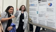 Trinity Erjo standing in front of her poster at NIH poster festival with Dr. Rami German