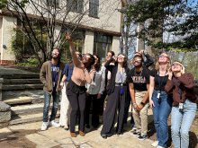 NNT lab members standing outside wearing solar eclipse glasses and viewing the April 8, 2024 eclipse.